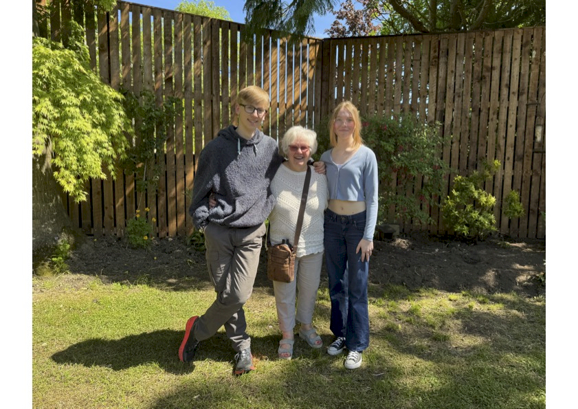 A couple of young people in our garden with a Friend